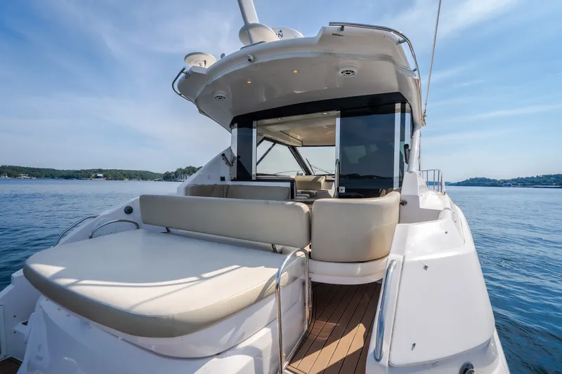 Slide: The Image of 2012 Regal 42 Sport Coupe yacht with spacious deck on calm water. - 17