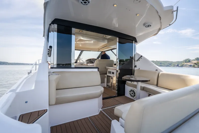 Slide: The Image of Luxurious 2012 Regal 42 Sport Coupe yacht interior with seating and scenic water view. - 19