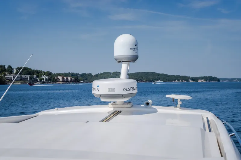 Slide: The Image of 2012 Regal 42 Sport Coupe yacht with Garmin radar on a serene lake. - 66