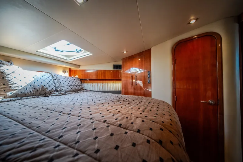 Slide: The Image of Luxurious cabin interior of 2012 Regal 42 Sport Coupe yacht with skylight and wood finish. - 53