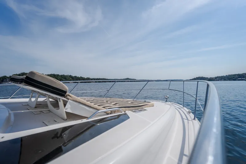 Slide: The Image of 2012 Regal 42 Sport Coupe yacht on serene water with clear skies. - 41