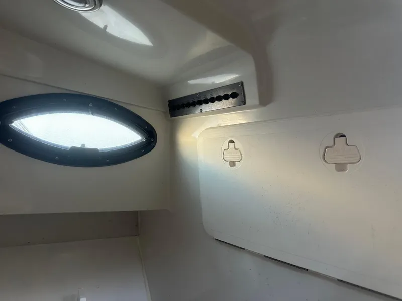 Slide: The Image of Interior view of a 2007 Sailfish 30-06 Express boat cabin with porthole window. - 3