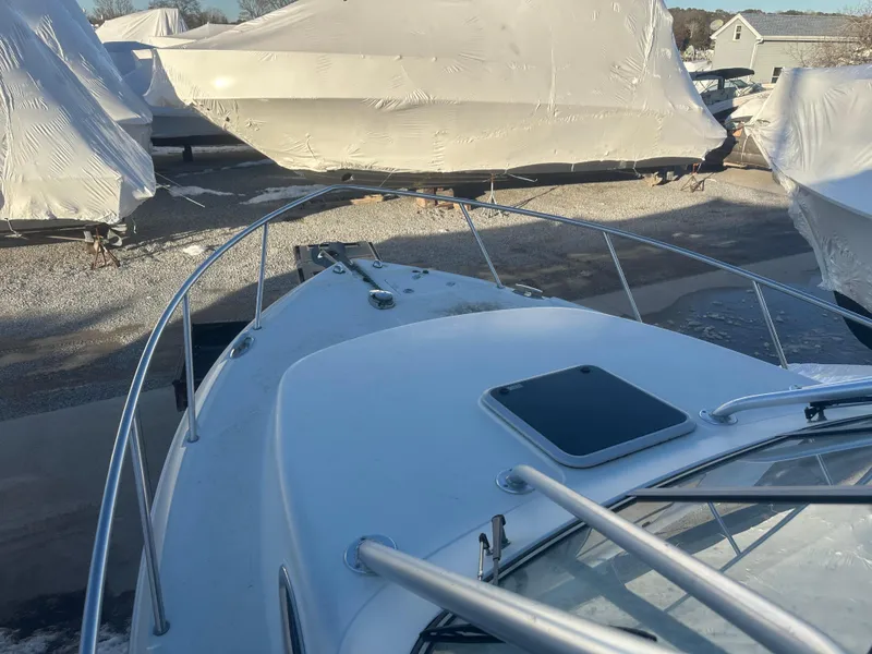 Slide: The Image of 2007 Sailfish 30-06 Express boat, docked with covered vessels in the background. - 5