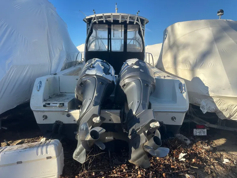 Slide: The Image of 2007 Sailfish 30-06 Express boat with dual outboard motors, stored outdoors. - 7