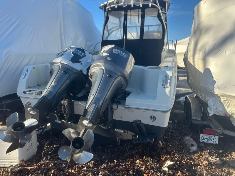 Slide: The Image of 2007 Sailfish 30-06 Express boat with dual outboard motors, stored outdoors. - 8