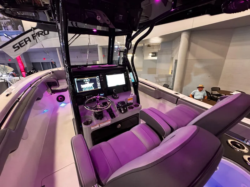 Slide: The Image of 2025 Sea Pro 292 DLX boat interior with modern dashboard and seating. - 10