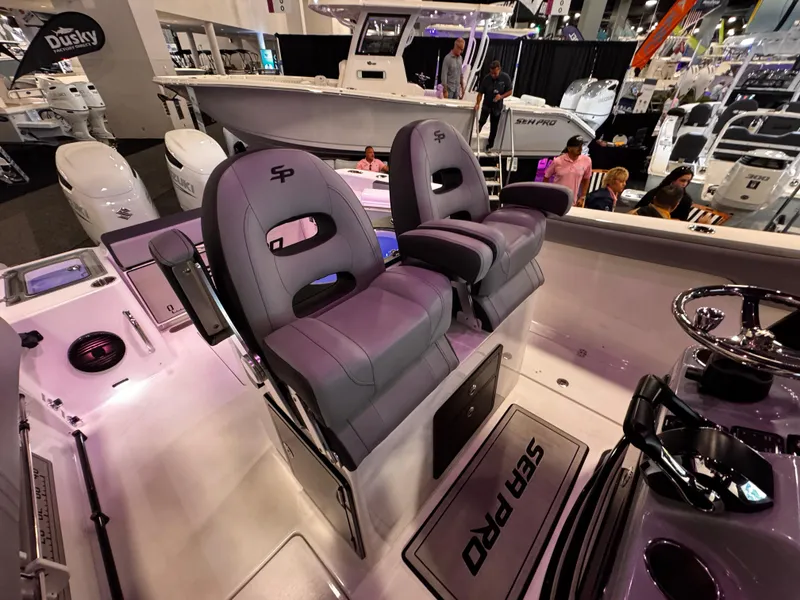 Slide: The Image of 2025 Sea Pro 292 DLX boat interior with dual seats at a boat show. - 24
