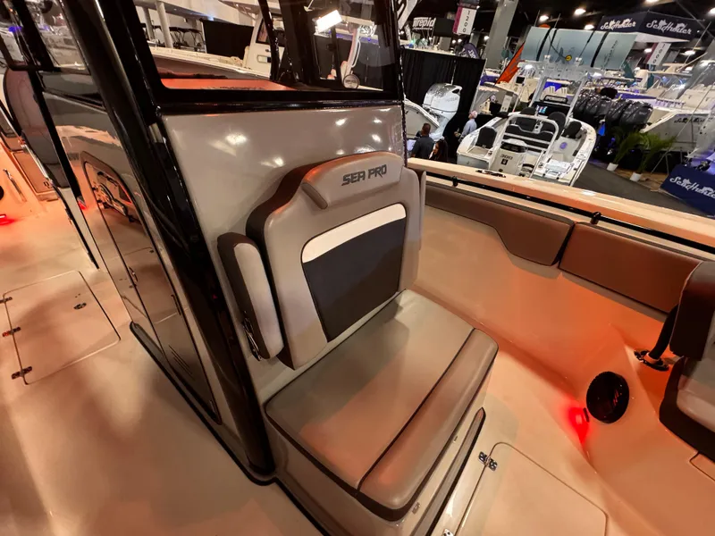 Slide: The Image of 2025 Sea Pro 292 DLX boat interior with seating at a boat show. - 27