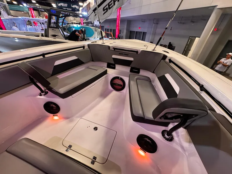 Slide: The Image of 2025 Sea Pro 292 DLX boat interior with seating and ambient lighting. - 30