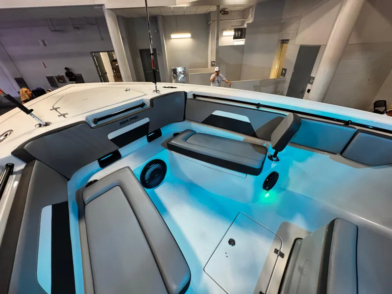Slide: The Image of 2025 Sea Pro 292 DLX boat interior with seating and ambient lighting. - 31