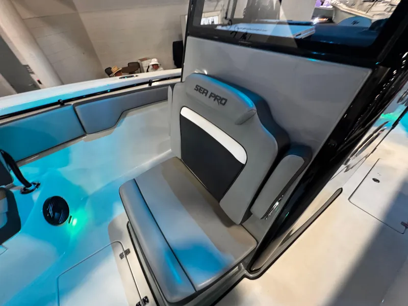 Slide: The Image of 2025 Sea Pro 292 DLX boat interior with cushioned seating and modern design. - 34
