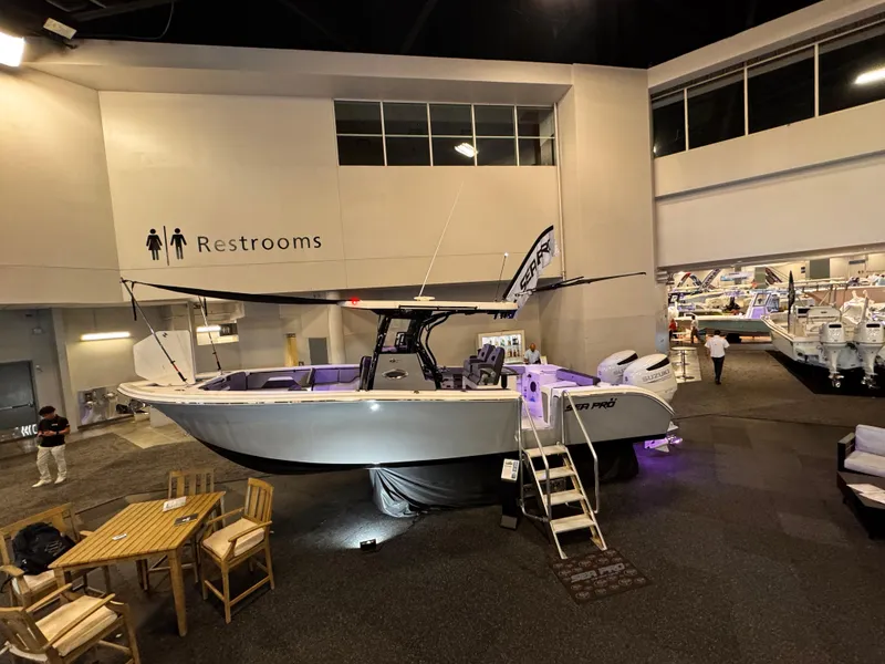 Slide: The Image of 2025 Sea Pro 292 DLX boat displayed indoors at a showroom. - 6