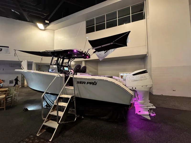 Slide: The Image of 2025 Sea Pro 292 DLX boat with purple lighting, displayed indoors. - 7