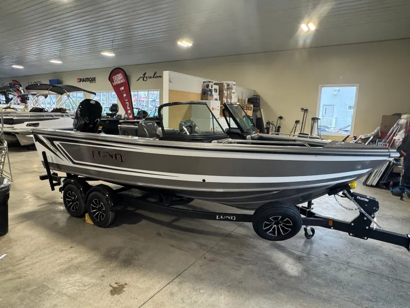 The Image of 2025 Lund 1975 Tyee boat on trailer in showroom, side view. - 2