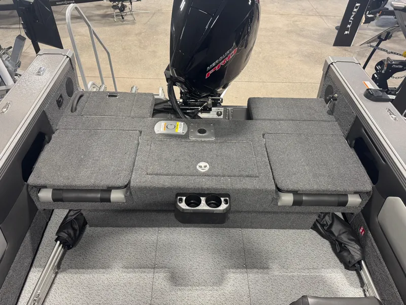 Slide: The Image of 2025 Lund 1975 Tyee boat interior with Mercury Pro outboard motor, gray seating, and cup holders. - 4