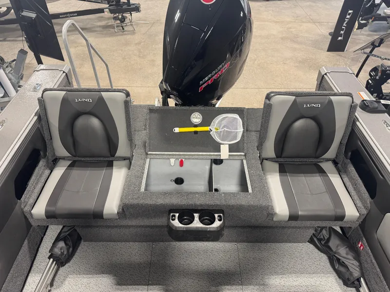 Slide: The Image of 2025 Lund 1975 Tyee boat interior with dual seats and Mercury engine. - 5