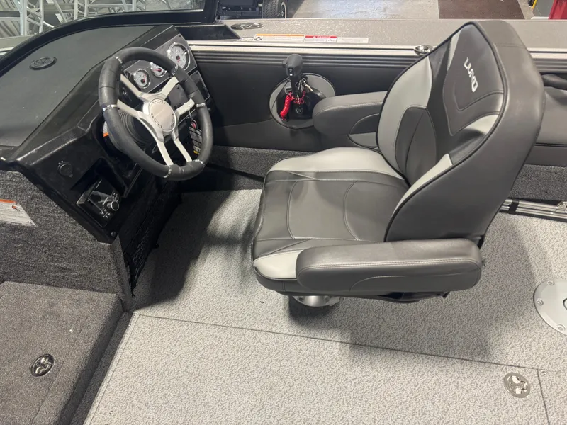 Slide: The Image of Interior of 2025 Lund 1975 Tyee boat with steering wheel and captain's chair. - 6