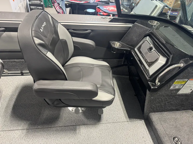 Slide: The Image of 2025 Lund 1975 Tyee boat interior with black and gray captain's chair and console. - 7