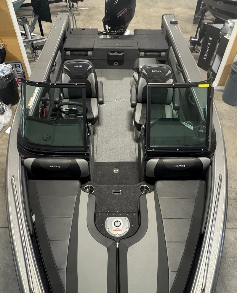 Slide: The Image of 2025 Lund 1975 Tyee boat interior with dual consoles and seating, viewed from above. - 9