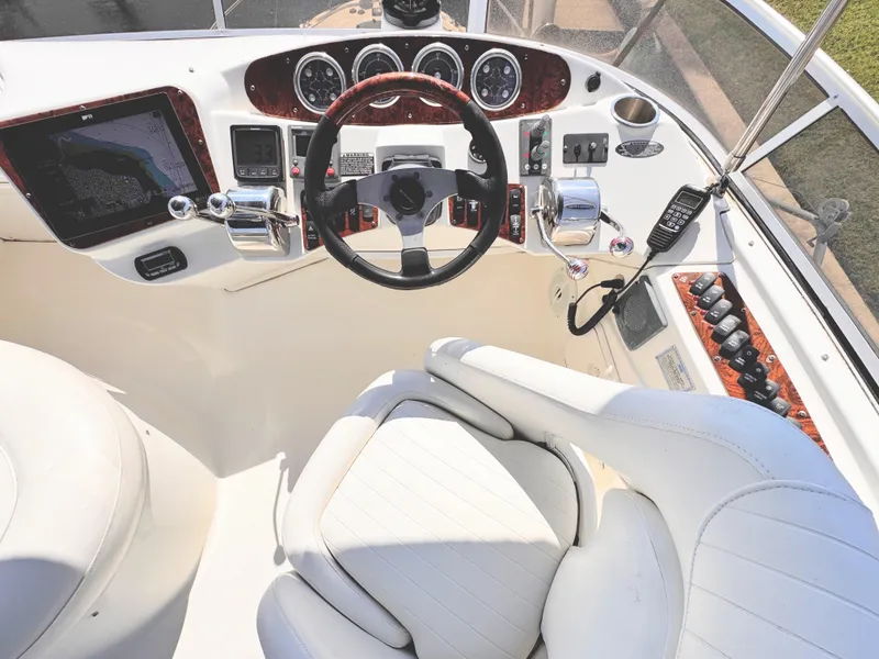 Slide: The Image of 2006 Meridian 341 Sedan helm with steering wheel, navigation controls, and white seating. - 14