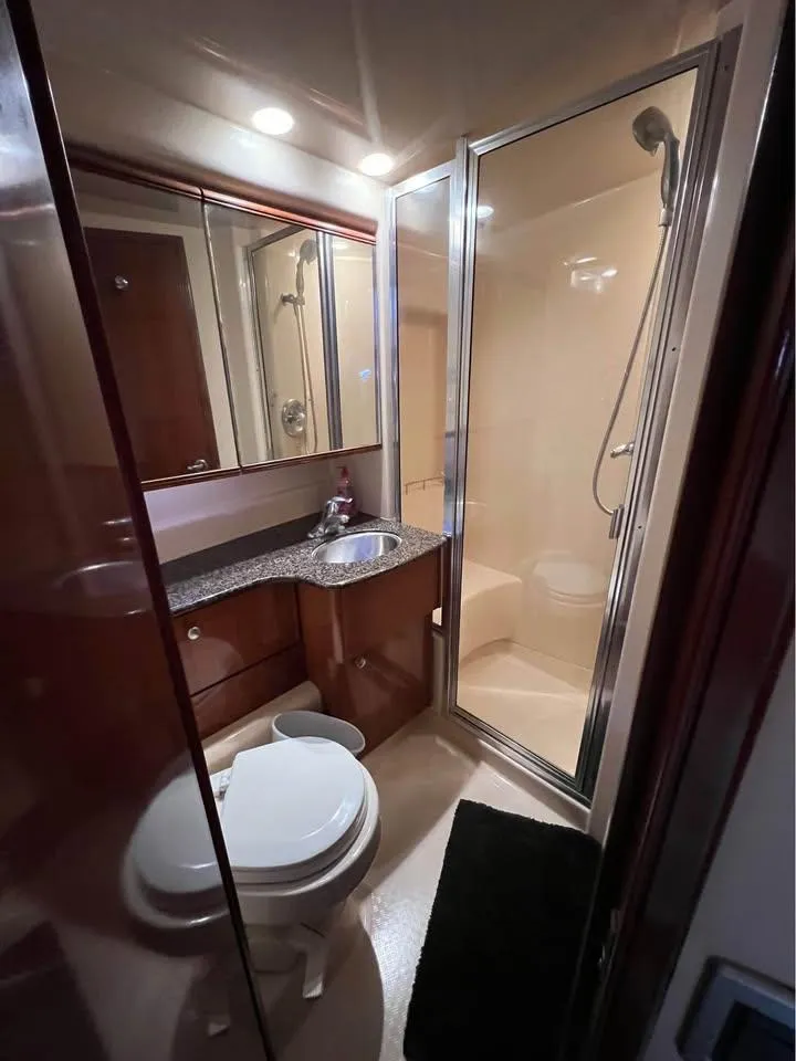 Slide: The Image of Luxurious bathroom in 2006 Meridian 341 Sedan yacht with shower, sink, and toilet. - 27