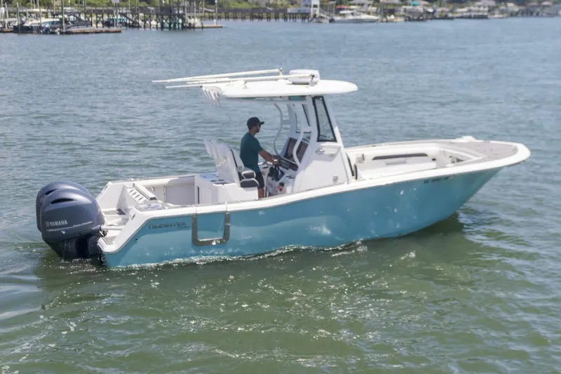Slide: The Image of 2021 Tidewater 256 CC Adventure boat cruising on calm waters. - 3