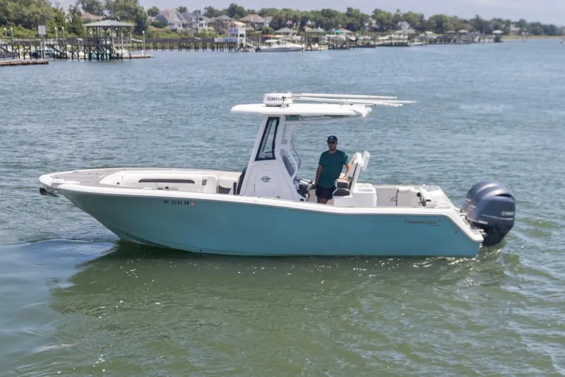 Slide: The Image of 2021 Tidewater 256 CC Adventure boat cruising on a sunny day. - 4