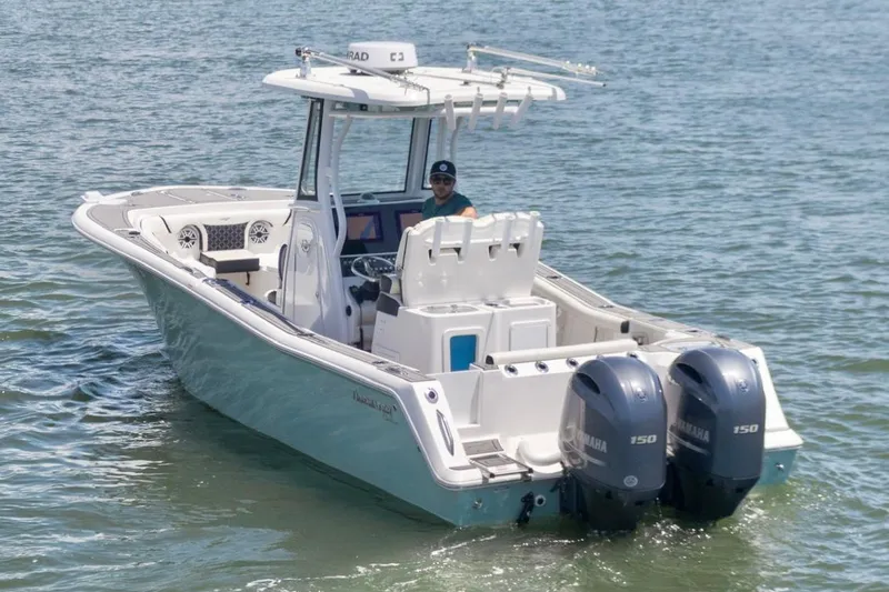 Slide: The Image of 2021 Tidewater 256 CC Adventure boat with dual Yamaha engines on the water. - 6