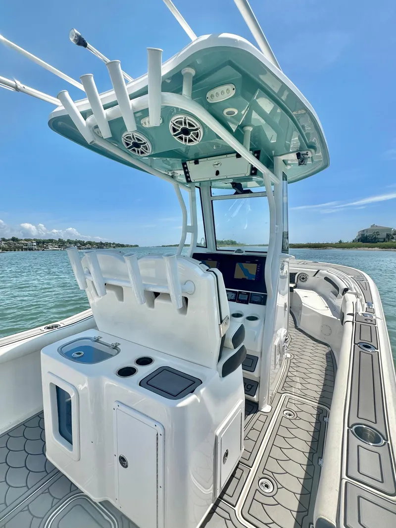 Slide: The Image of 2021 Tidewater 256 CC Adventure boat interior with helm, seating, and ocean view. - 7