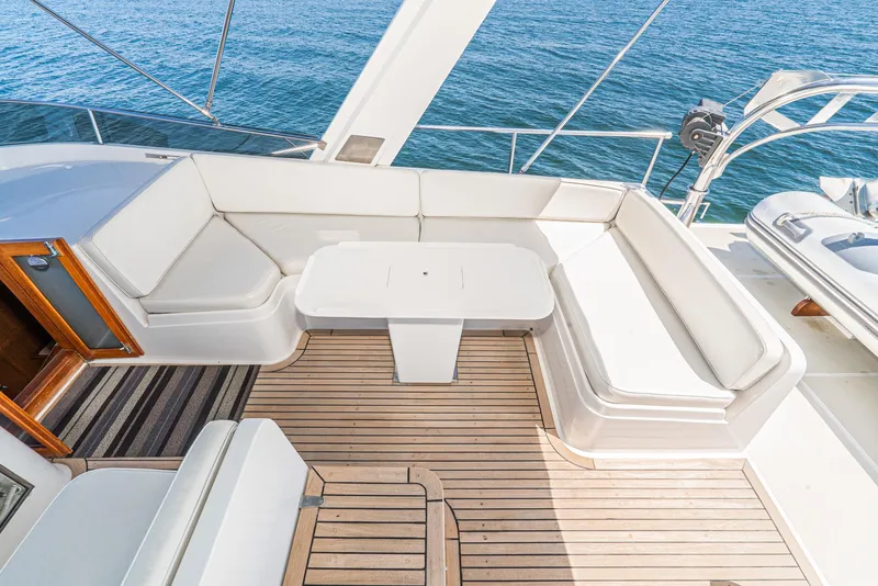 Slide: The Image of 1987 Fleming 50 Raised Pilothouse yacht with spacious deck seating and ocean view. - 11