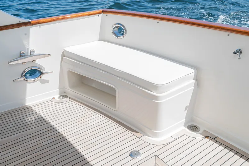 Slide: The Image of Fleming 50 Raised Pilothouse 1987 boat deck with white bench and ocean view. - 12