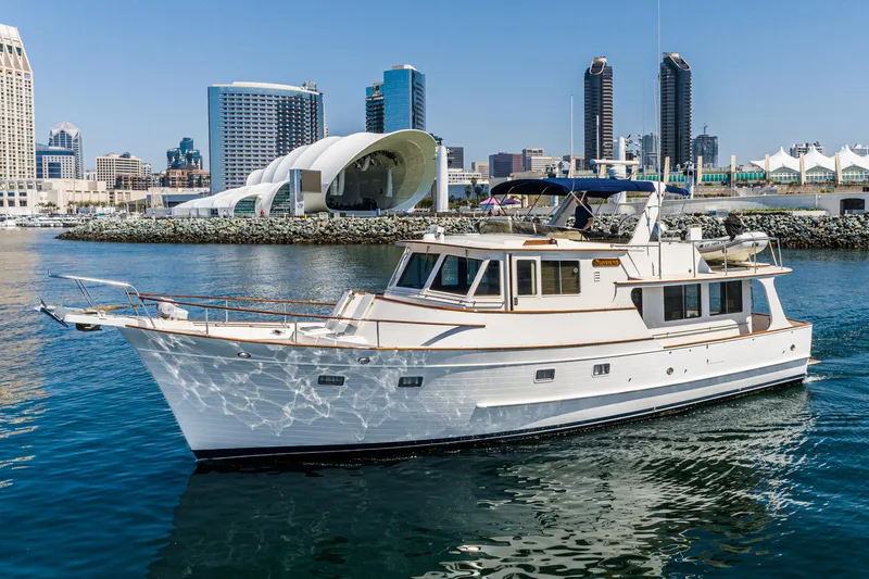 Slide: The Image of 1987 Fleming 50 Raised Pilothouse yacht cruising in urban waterfront setting. - 2