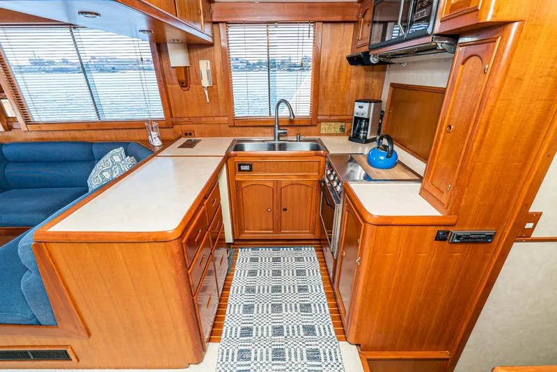 Slide: The Image of Cozy kitchen in 1987 Fleming 50 Raised Pilothouse yacht with wood cabinetry and modern appliances. - 21