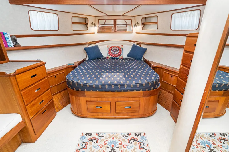 Slide: The Image of Luxurious 1987 Fleming 50 Raised Pilothouse cabin with elegant wood finish and cozy bedding. - 26