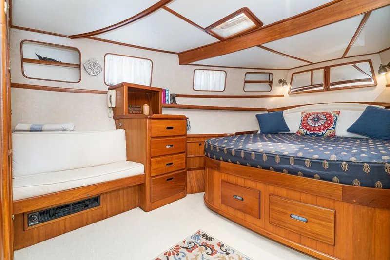 Slide: The Image of 1987 Fleming 50 Raised Pilothouse cabin with wood furnishings and cozy bed. - 27