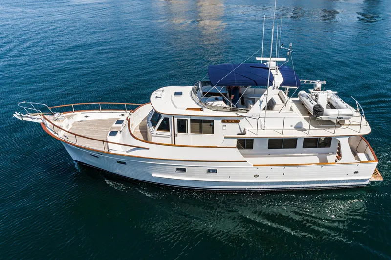 Slide: The Image of 1987 Fleming 50 Raised Pilothouse yacht cruising on calm blue waters. - 3