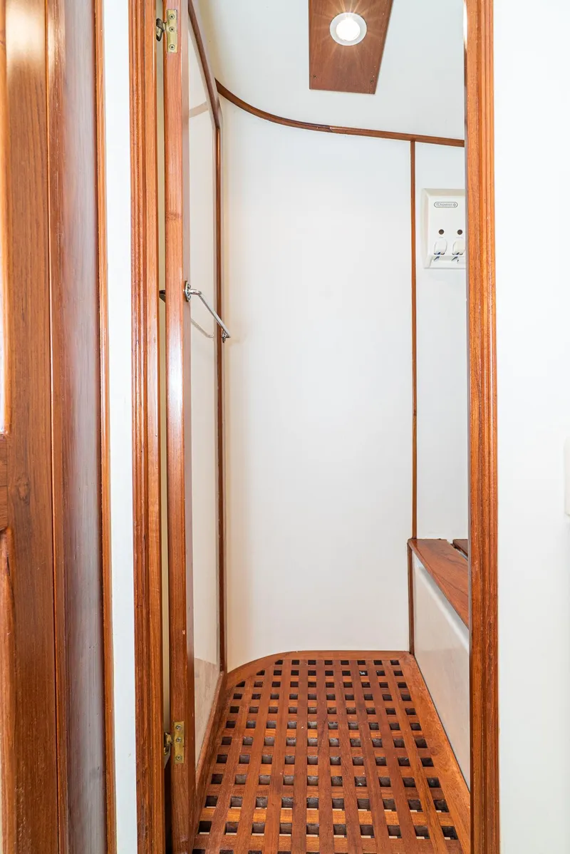 Slide: The Image of 1987 Fleming 50 Raised Pilothouse shower with wooden accents and lattice flooring. - 30