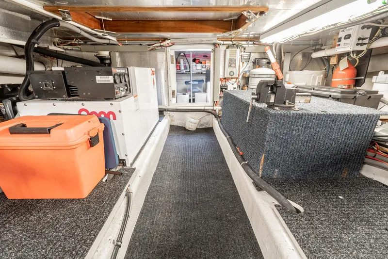 Slide: The Image of Engine room of 1987 Fleming 50 Raised Pilothouse yacht, featuring equipment and storage. - 32