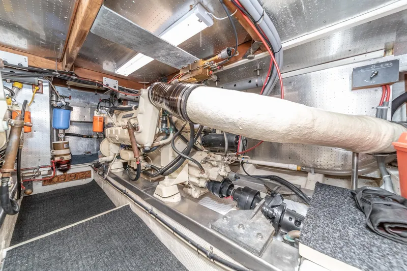 Slide: The Image of Engine room of 1987 Fleming 50 Raised Pilothouse yacht, showcasing mechanical components and wiring. - 36