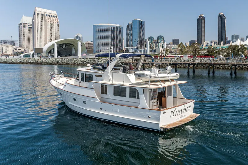 Slide: The Image of 1987 Fleming 50 Raised Pilothouse yacht cruising in urban waterfront setting. - 4