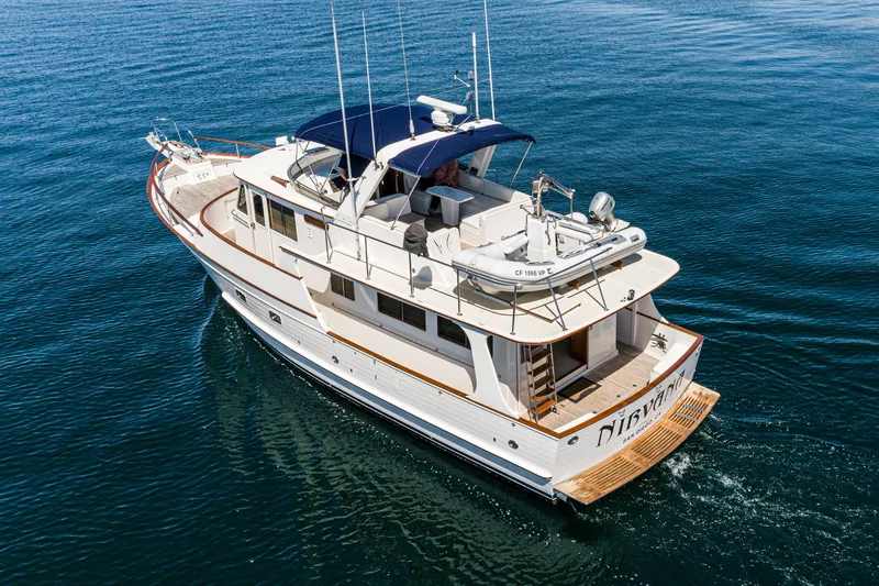 Slide: The Image of 1987 Fleming 50 Raised Pilothouse yacht cruising on calm blue waters. - 5