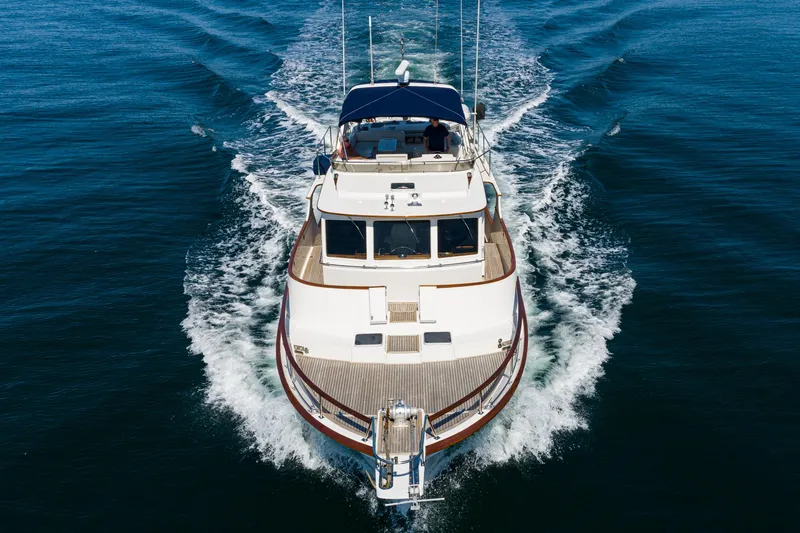 Slide: The Image of 1987 Fleming 50 Raised Pilothouse yacht cruising on open water, aerial view. - 6