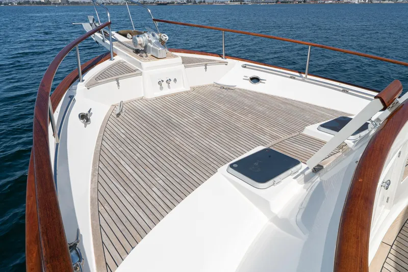 Slide: The Image of 1987 Fleming 50 Raised Pilothouse yacht deck with wooden railings and ocean view. - 8