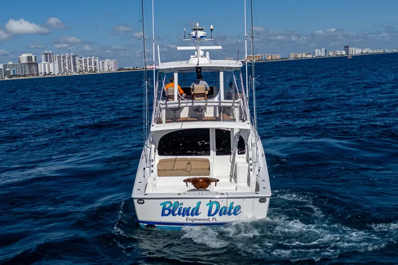 Slide: The Image of Viking 46 Convertible yacht, 2016 model, cruising in open water near city skyline. - 10