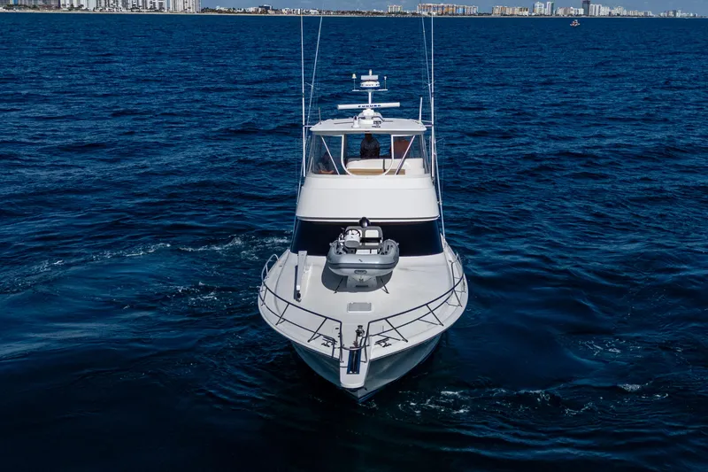 Slide: The Image of 2016 Viking 46 Convertible yacht cruising on open water. - 13