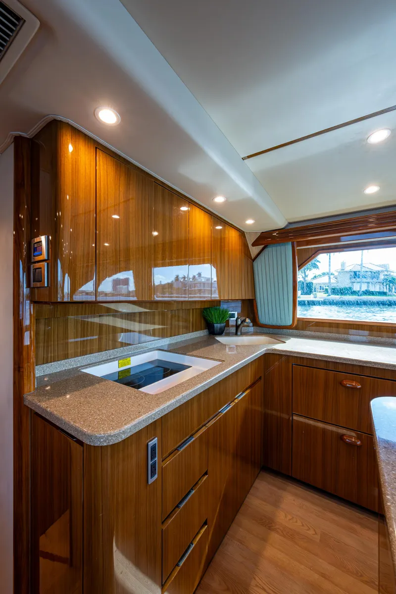 Slide: The Image of Luxurious kitchen interior of 2016 Viking 46 Convertible yacht with wood cabinetry and modern appliances. - 20