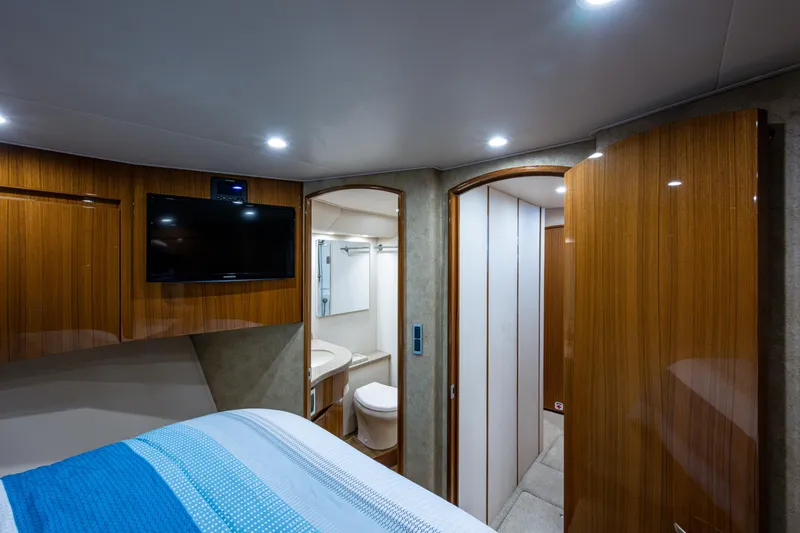 Slide: The Image of Interior of 2016 Viking 46 Convertible yacht with modern wood finish and cozy bedroom. - 25