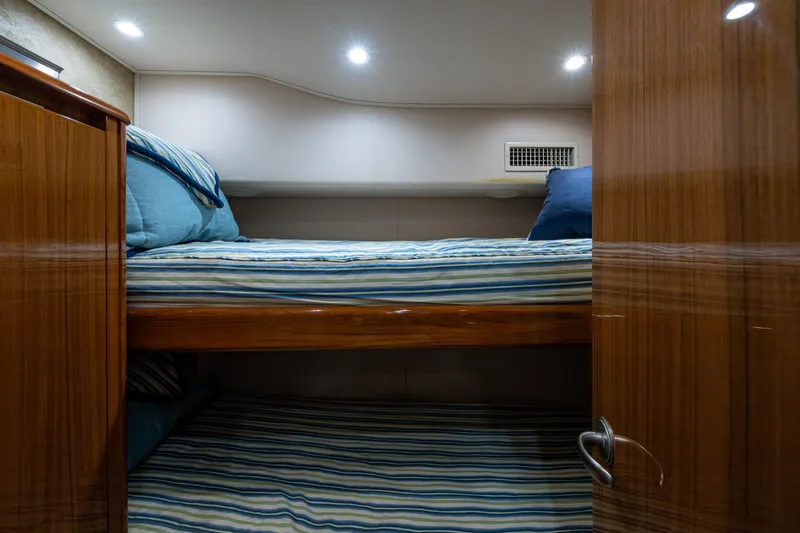 Slide: The Image of Bunk beds in 2016 Viking 46 Convertible yacht cabin with striped bedding. - 30