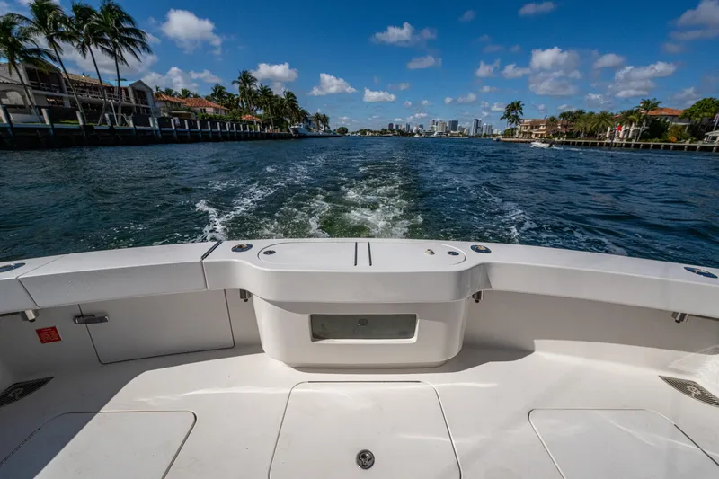 Slide: The Image of 2016 Viking 46 Convertible yacht cruising on a sunny day, with scenic waterfront views. - 41