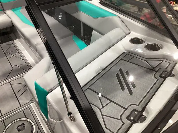 Slide: The Image of 2024 ATX Surf Boats 22ATX interior with gray and teal seating, cup holders, and sleek design. - 11